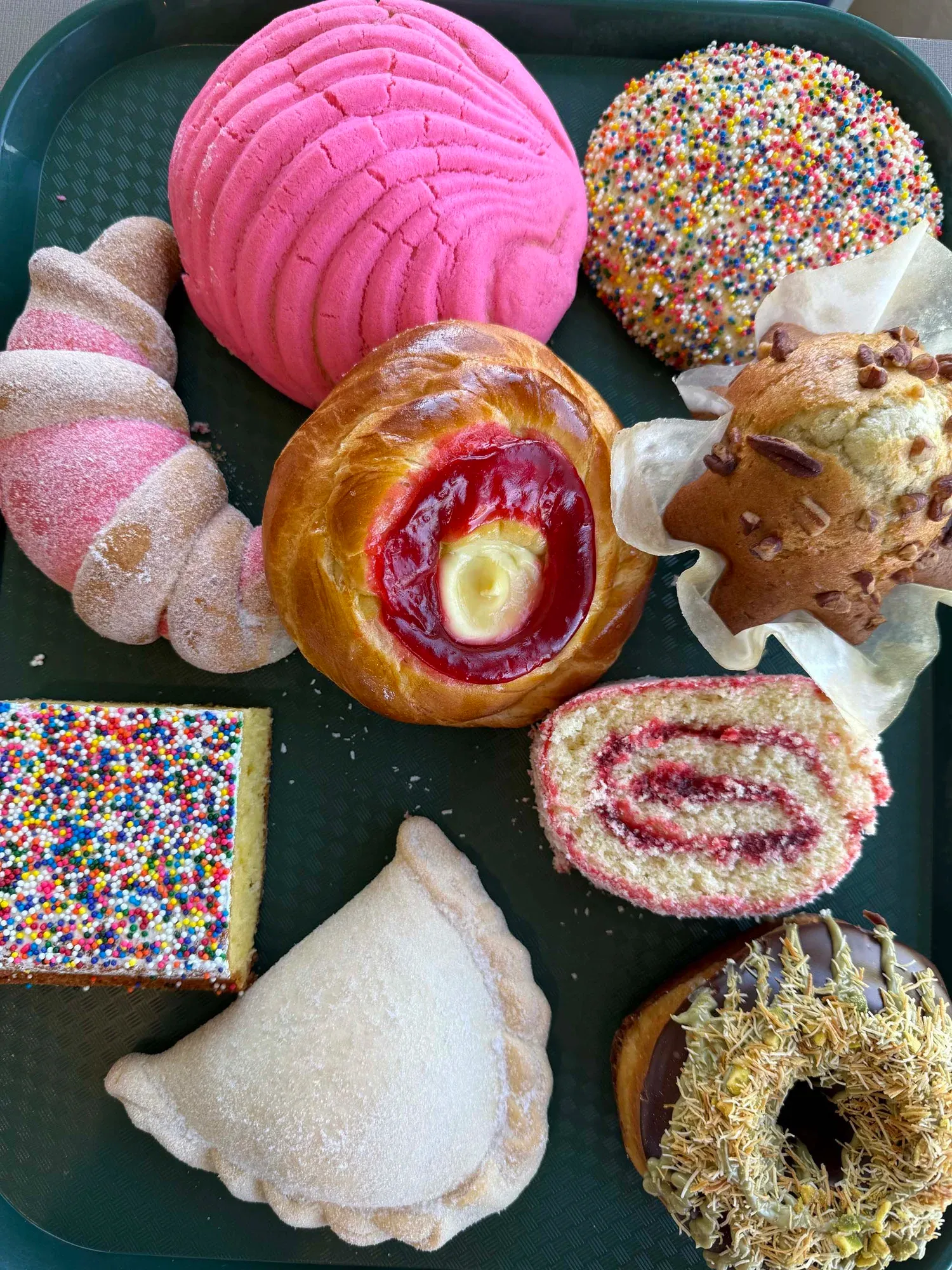 A colorful assortment of conchas, pastries, and Mexican sweet breads