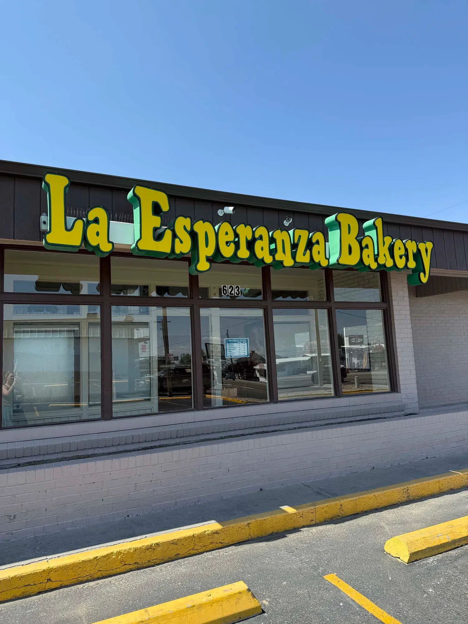 La Esperanza Bakery storefront with its yellow and green sign